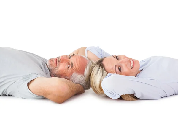 Smiling couple lying and looking at camera — Stock Photo, Image