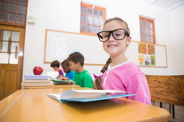 Cute pupils reading at desks — Stock Photo, Image