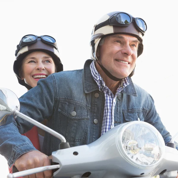 Happy senior couple riding a moped — Stock Photo, Image