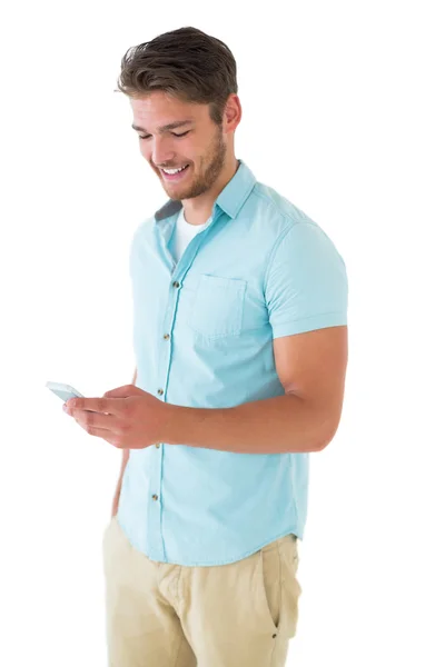 Handsome young man using his smartphone — Stock Photo, Image