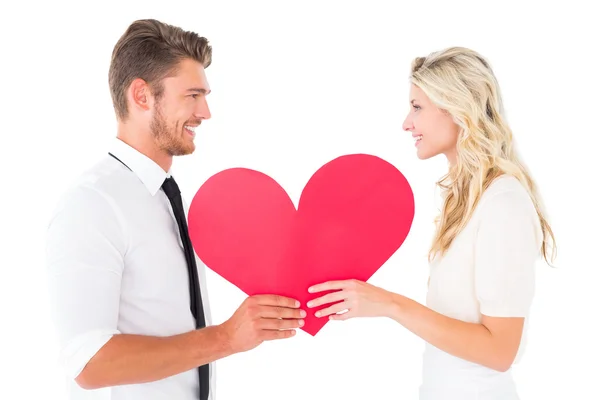 Atractiva pareja joven sosteniendo el corazón rojo — Foto de Stock