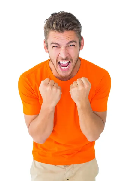 Excited man in orange cheering — Stock Photo, Image