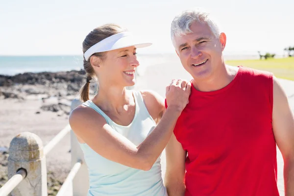 Fit mature couple warming up together on the pier — Stock Photo, Image