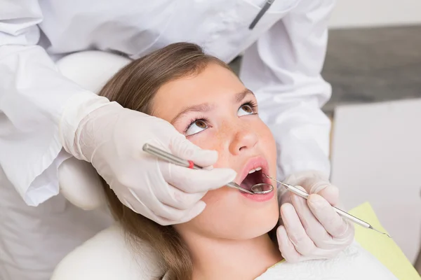 Pediatric dentist examining a patients teeth Royalty Free Stock Images