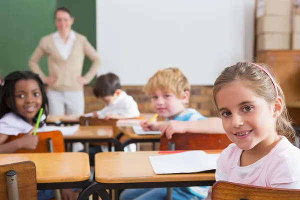 Pupils and teacher in classroom Stock Picture