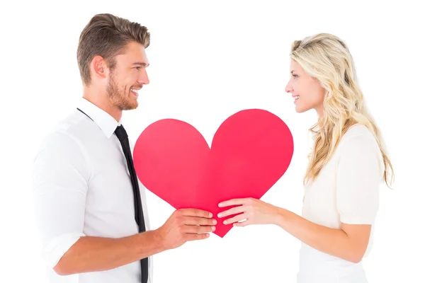 Attractive young couple holding red heart Stock Image