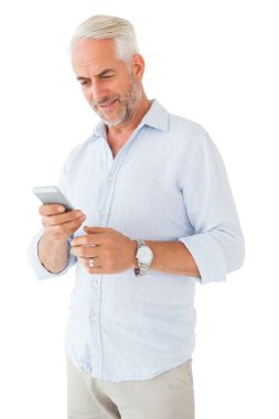 Smiling man sending a text message clipart