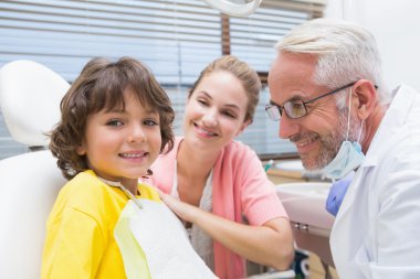 Boy with mother and dentist clipart