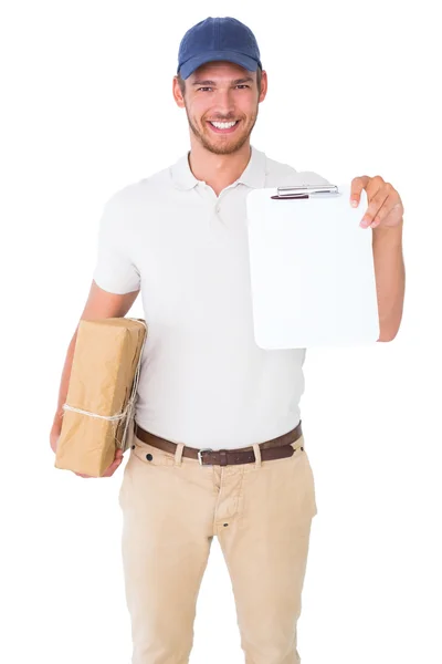 Happy delivery man holding cardboard box and clipboard — Stock Photo, Image