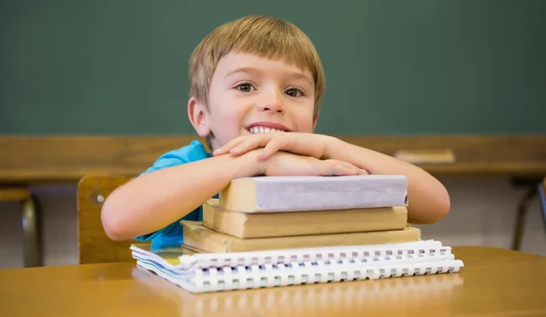 Pupil leaning on books at desk — Stock Photo, Image