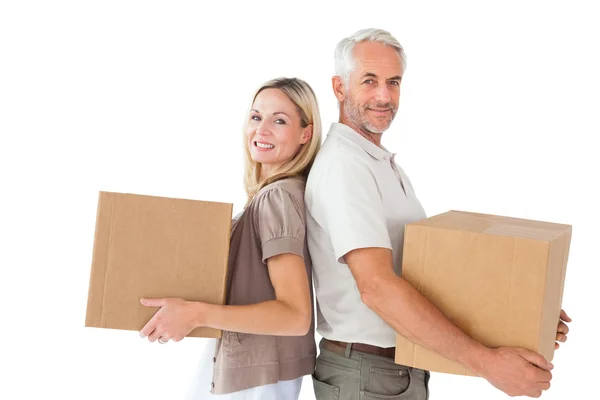 Happy couple holding moving boxes — Stock Photo, Image