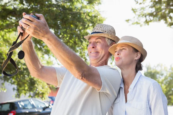 Lyckliga äldre par poserar för en selfie — Stockfoto