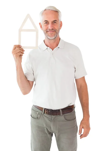 Happy man holding house outline — Stock Photo, Image