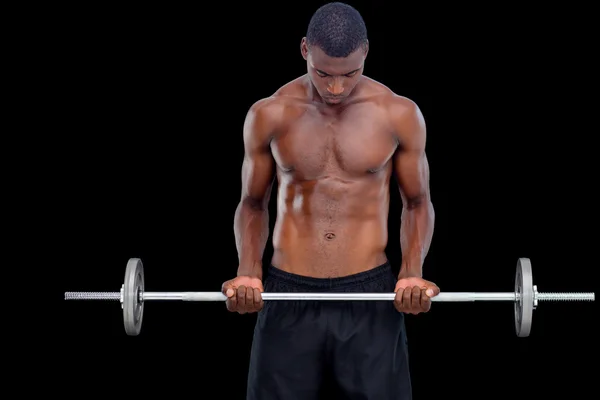 Sério homem apto levantando barbell — Fotografia de Stock