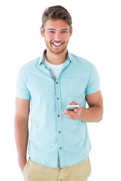 Handsome young man using his smartphone — Stock Photo, Image