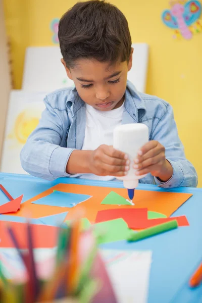 Little boy making art in classroom — Stock Photo, Image