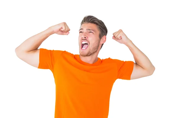 Excited man in orange cheering — Stock Photo, Image