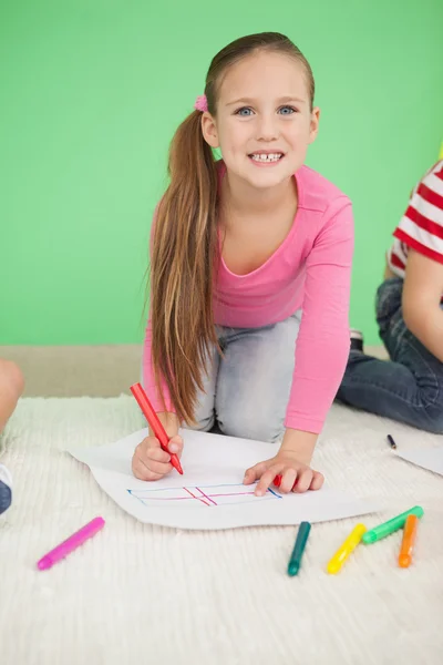 Cute little schoolgirl drawing — Stock Photo, Image