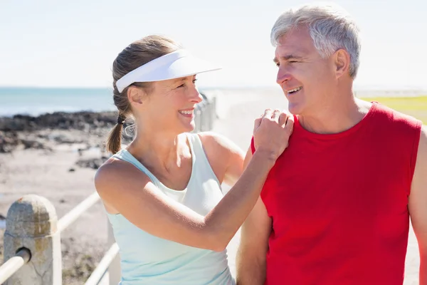 Fit mature couple warming up together on the pier — Stock Photo, Image