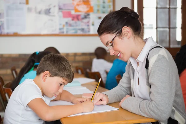 Läraren hjälper eleven i klassrummet — Stockfoto