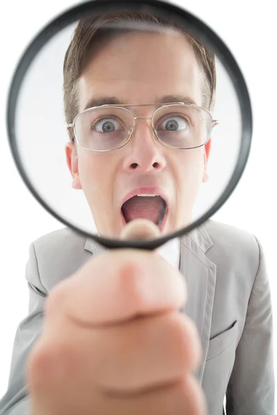 Excited businessman looking through magnifying glass — Stock Photo, Image