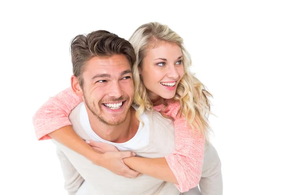 Handsome man giving piggy back to his girlfriend — Stock Photo, Image