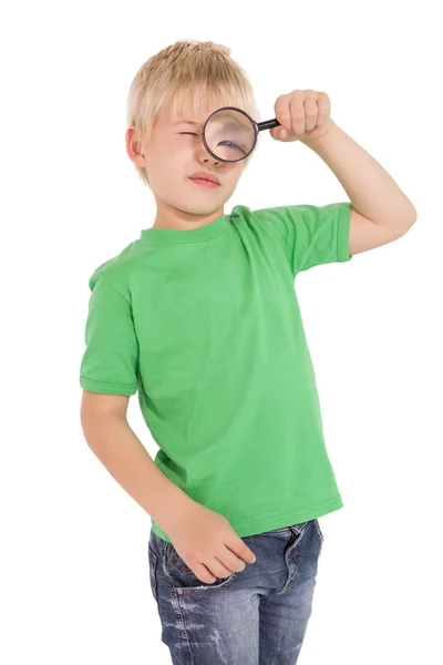 Cute little boy looking through magnifying glass — Stock Photo, Image