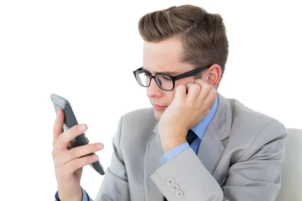 Nerdy businessman looking at his calculator — Stock Photo, Image