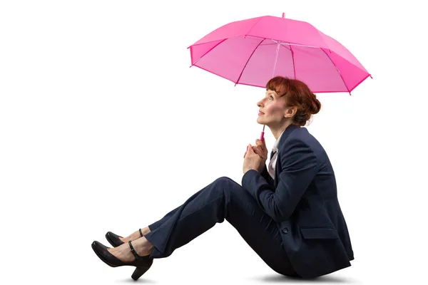 Sitting businesswoman holding pink umbrella — Stock Photo, Image