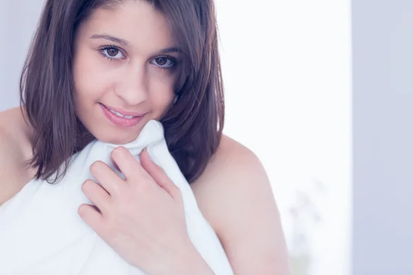 Beautiful brunette hugging her pillow — Stock Photo, Image