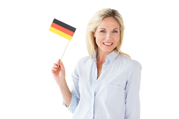 Smiling blonde woman holding german flag — Stock Photo, Image