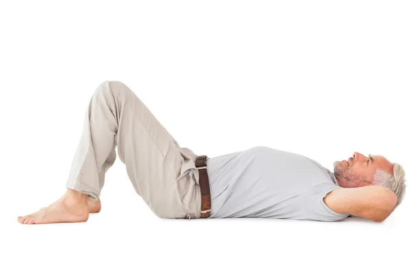 Smiling man lying and looking up — Stock Photo, Image