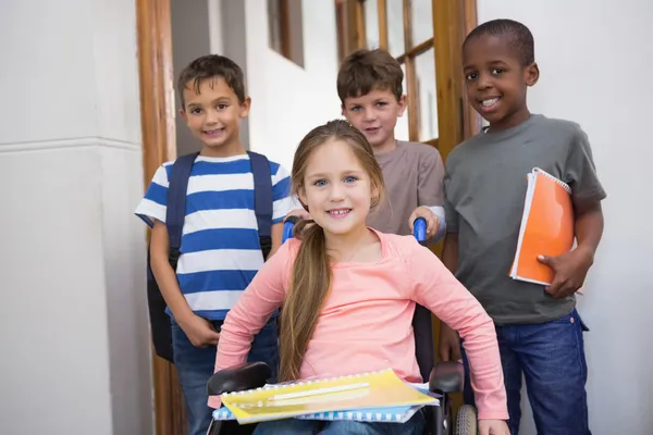 Disabled pupil with his friends in classroom — Stock Photo, Image