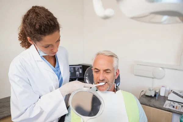 Patient admiring his new smile in the mirror — Stock Photo, Image