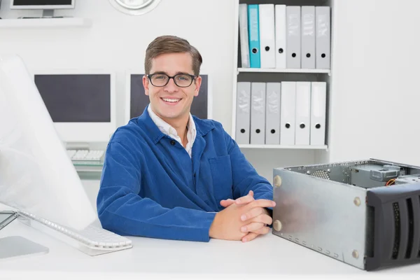 Smiling technician sitting at desk — Stock Photo, Image