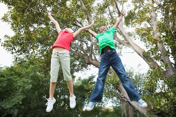 Cute children jumping up outside — Stock Photo, Image