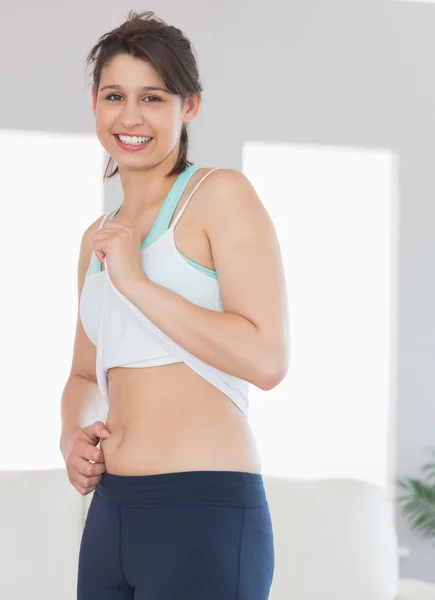 Fit brunette pinching her stomach — Stock Photo, Image