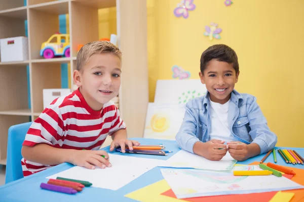 Little boys drawing at desk — Stock Photo, Image