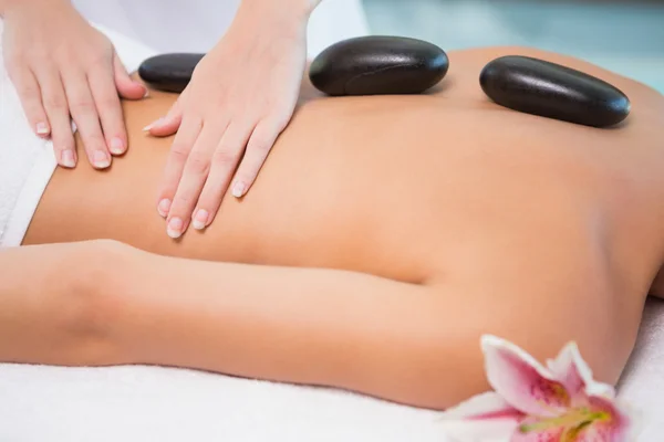 Beautiful woman receiving stone massage at health farm — Stock Photo, Image