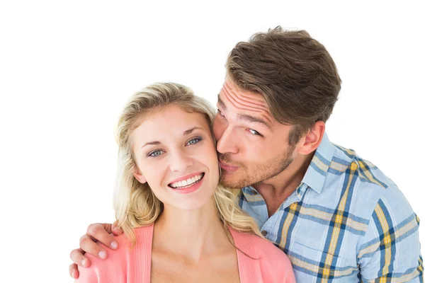 Handsome man kissing girlfriend on cheek — Stock Photo, Image