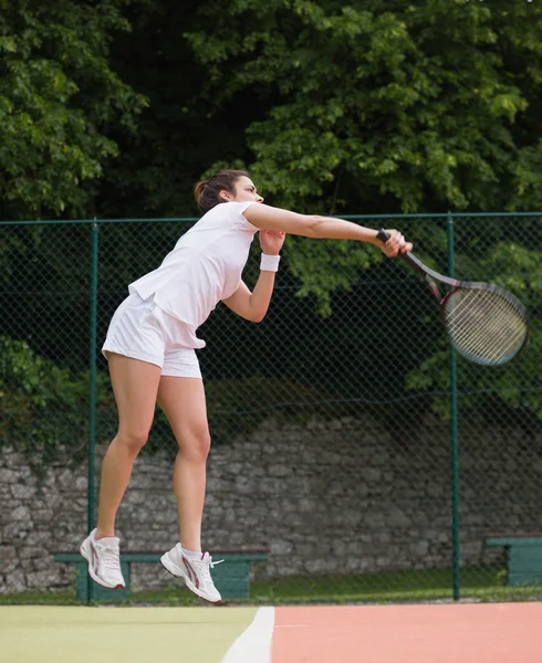 Pretty tennis player jumping and hitting — Stock Photo, Image