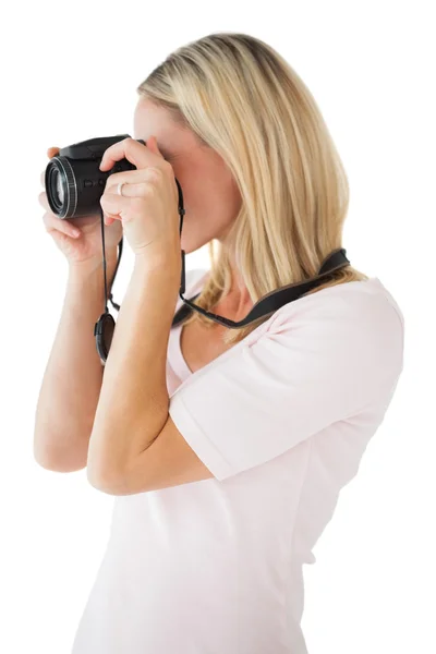 Happy blonde taking a photo on camera — Stock Photo, Image