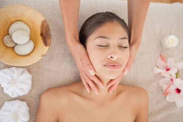 Beautiful brunette enjoying head massage — Stock Photo, Image