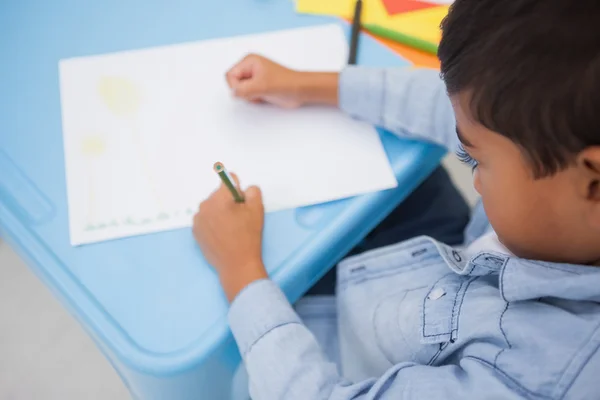 Cute little boy drawing at desk — Stock Photo, Image