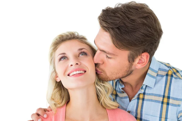 Handsome man kissing girlfriend on cheek Royalty Free Stock Photos