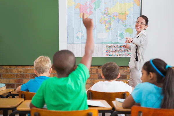 Pupil raising hand in classroom Royalty Free Stock Images