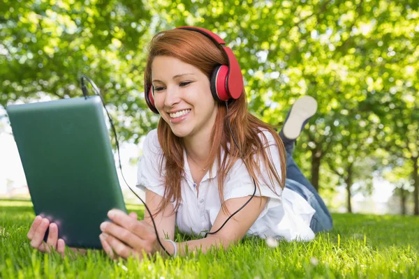 Redhead using her tablet pc — Stock Photo, Image