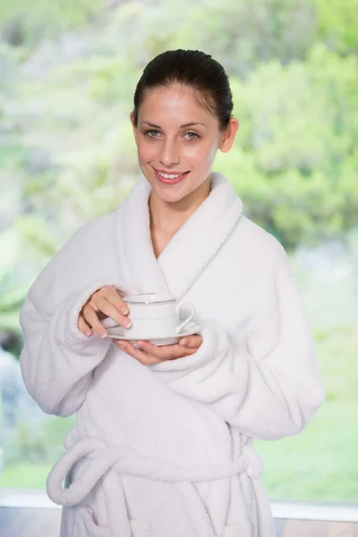 Beautiful woman in bathrobe having tea — Stock Photo, Image