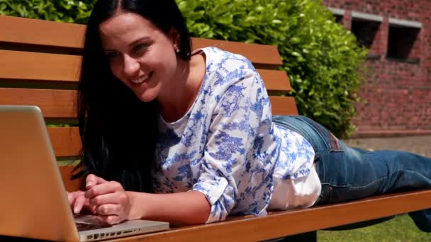 Woman on park bench using laptop — Stock Video