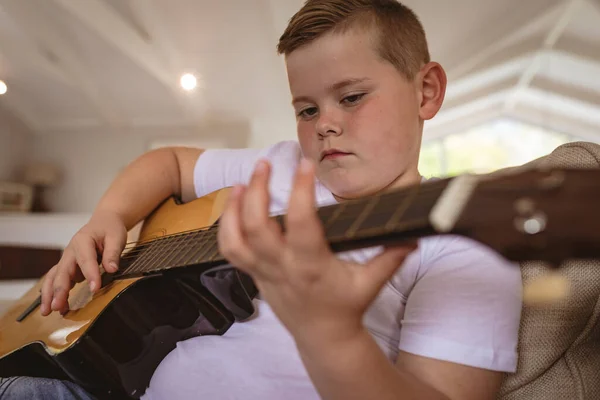 Close Caucasian Boy Playing Guitar Sitting Couch Home Childhood Hobby — Stock Photo, Image
